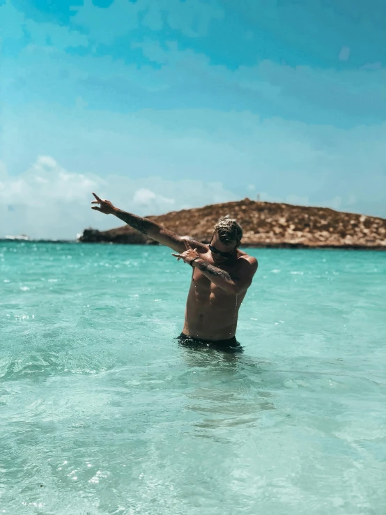 a man in the water throwing a frisbee, pexels contest winner, happening, islands!!!!!, doing a sassy pose, cyprus, pose(arms up + happy)