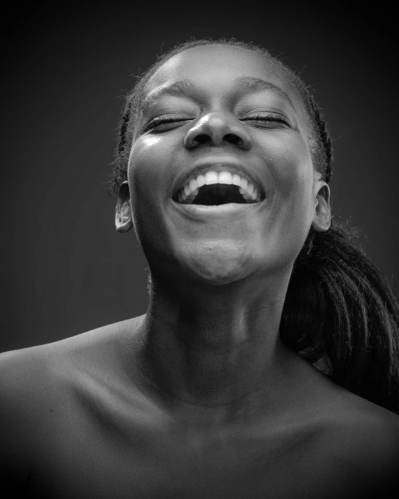 a black and white photo of a woman laughing, inspired by Carrie Mae Weems, pexels contest winner, adut akech, happy with his mouth open, face is brightly lit, photo of a black woman