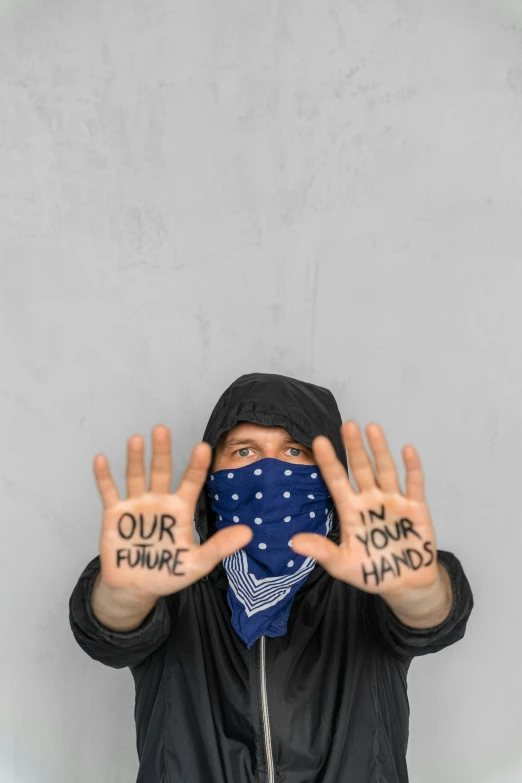 a man wearing a bandana covering his face with his hands, unsplash, graffiti, future activist, ilustration, instagram post, year 2099