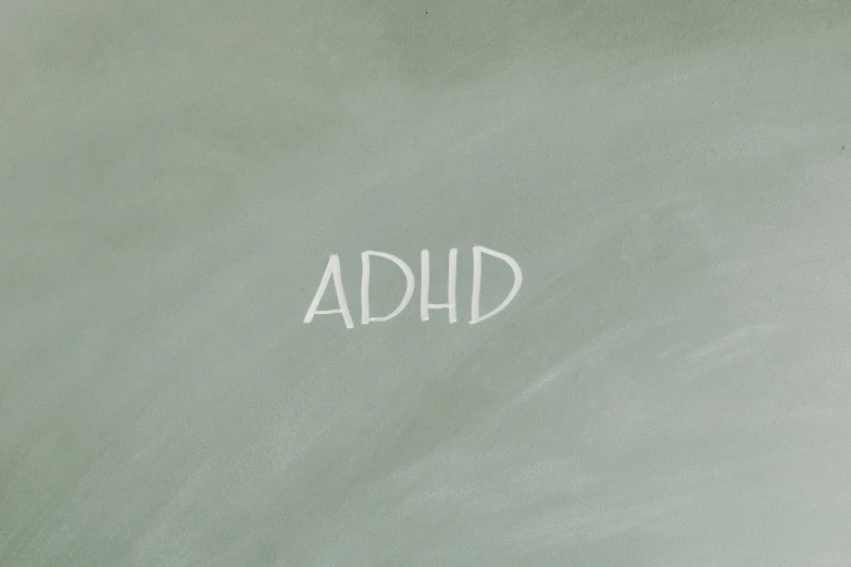 a blackboard with the word adhd written on it, very dull muted colors, album, grey, 2045