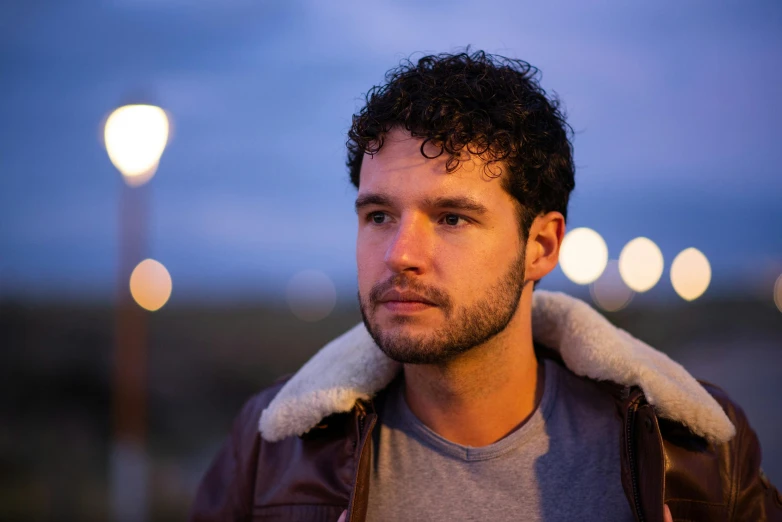 a close up of a person wearing a jacket, a portrait, unsplash, jon snow, evening lights, verbena, peruvian looking