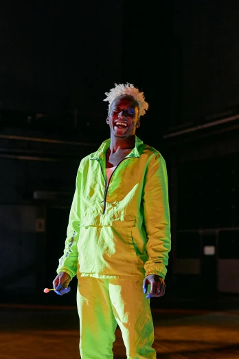 a man standing on a skateboard in a parking lot, an album cover, by Everett Warner, unsplash, visual art, neon colored suit, bright green hair, adut akech, standing in a dimly lit room