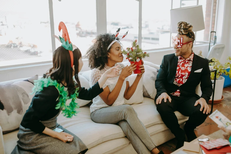 a group of people sitting on top of a couch, pexels contest winner, wearing festive clothing, plants in glasses, people at work, flirting