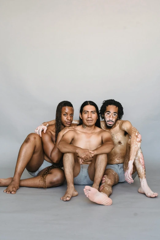 a group of naked people sitting next to each other, a portrait, feathers growing out of skin, calarts, skin color, trio