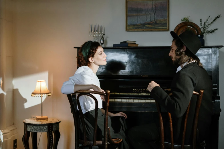 a man and a woman sitting in front of a piano, inspired by Vasily Perov, pexels contest winner, still from the movie the arrival, colour photograph, mina petrovic, jen atkin