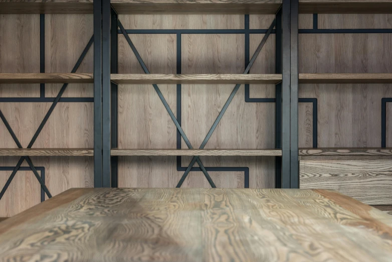 a wooden table sitting on top of a wooden floor, a digital rendering, inspired by Donald Judd, unsplash, arts and crafts movement, wall to wall bookcases, steel and metal, closeup shot, made of intricate metal and wood