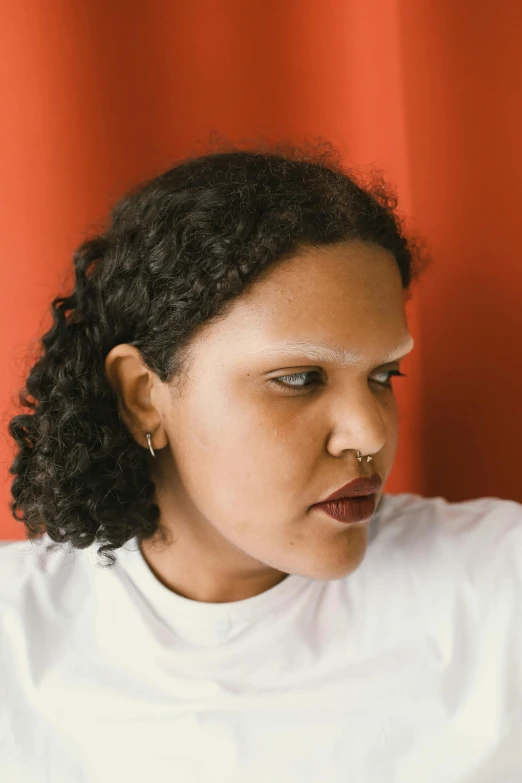 a woman holding a cell phone up to her ear, an album cover, by Lily Delissa Joseph, looking serious, without eyebrows, mixed-race woman, transgender