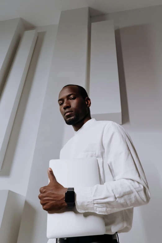 a man in a white shirt and black pants, an album cover, inspired by Paul Georges, pexels contest winner, kevin garnett, holding notebook, looking away from camera, technologies
