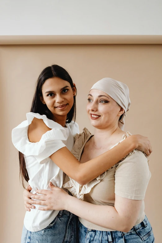 a couple of women standing next to each other, trending on pexels, renaissance, white ribbon, tumours, turban, supportive