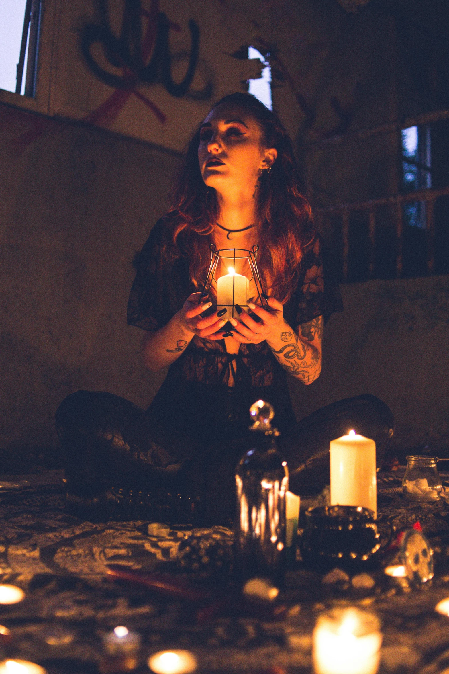 a woman sitting on the ground surrounded by candles, a portrait, trending on pexels, renaissance, female occultist, grungy gothic, holding a crystal ball, profile image