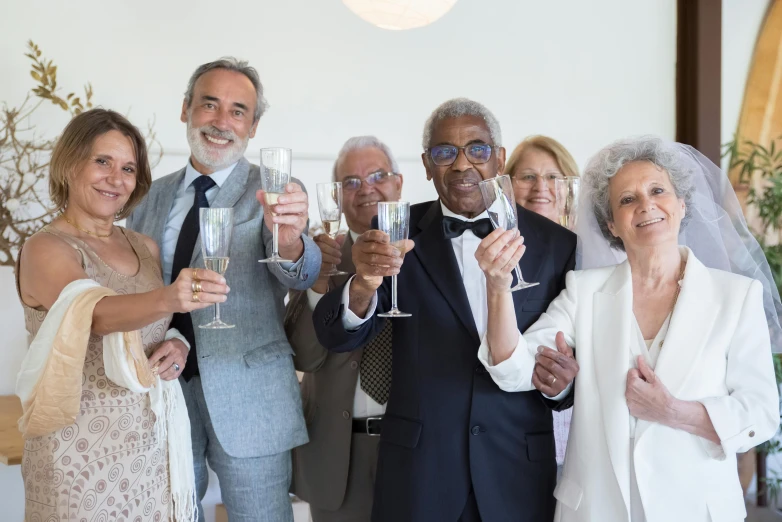a group of people standing next to each other holding wine glasses, elderly, 15081959 21121991 01012000 4k, luxurious wedding, an ultra realistic