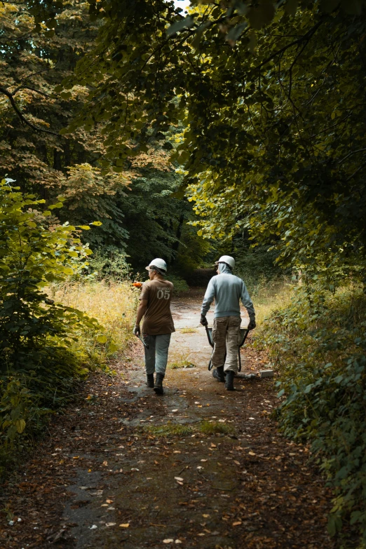 two people walking down a path in the woods, a portrait, inspired by William Stott, unsplash, photo from the dig site, fishing, riding, overlooking