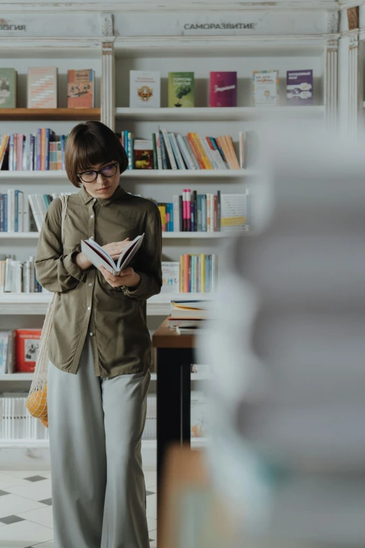 a woman reading a book in a library, by Jang Seung-eop, trending on pexels, modernism, dressed with fluent clothes, non-binary, wearing business casual dress, standing in class