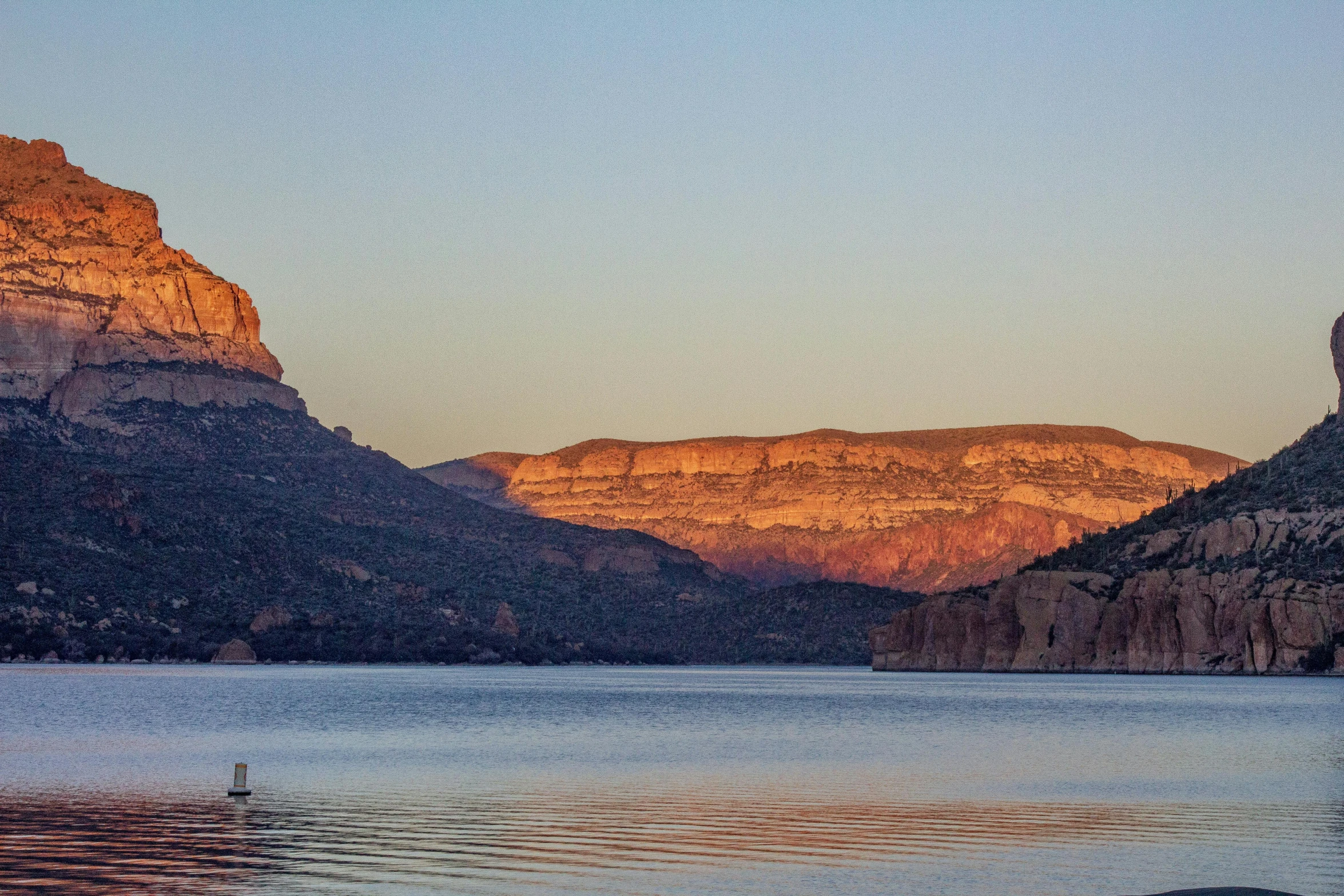 a body of water with a mountain in the background, pexels contest winner, plein air, grand canyon | golden hour, mountain lake, black mesa, panoramic