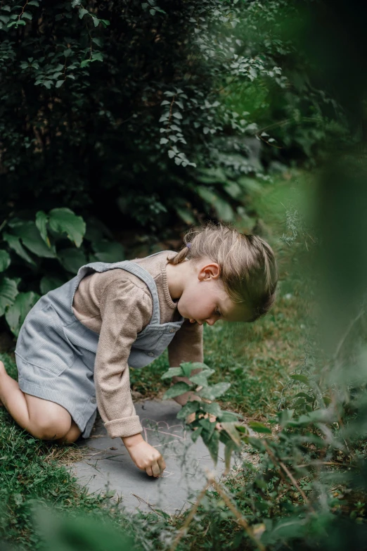 a small child playing in a puddle of water, inspired by Elsa Beskow, unsplash, with soft bushes, sustainable materials, maus in forest, grey