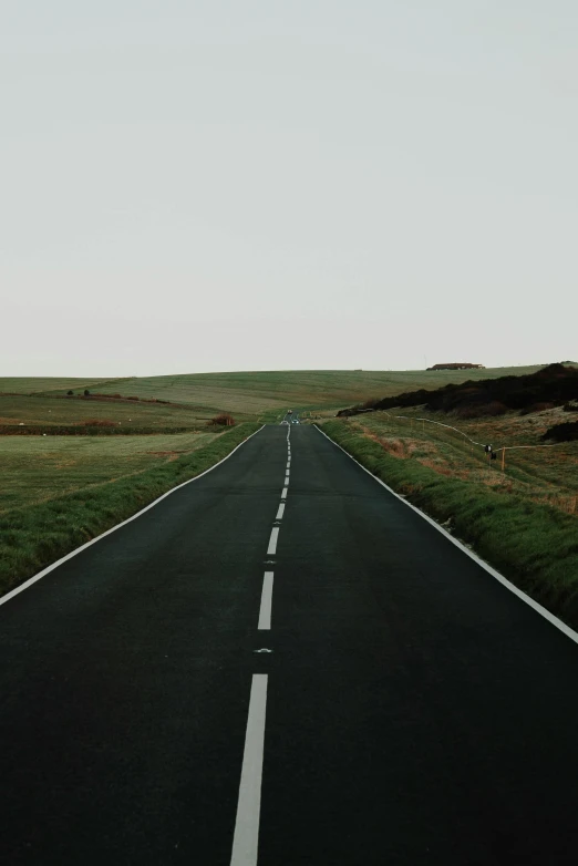 an empty road in the middle of nowhere, an album cover, unsplash, postminimalism, rolling green hills, black, college, 🚿🗝📝