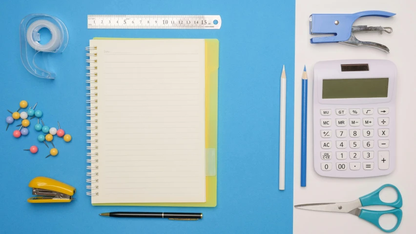 a calculator, pencils, scissors, and other office supplies on a blue surface, by Julia Pishtar, notebook, proportional image, no - text no - logo, thumbnail