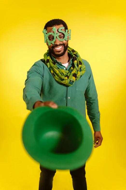 a man in a green shirt holding a green frisbee, inspired by Ras Akyem, shutterstock contest winner, west africa mask patterns style, cosplay photo, pots of gold, studio photo