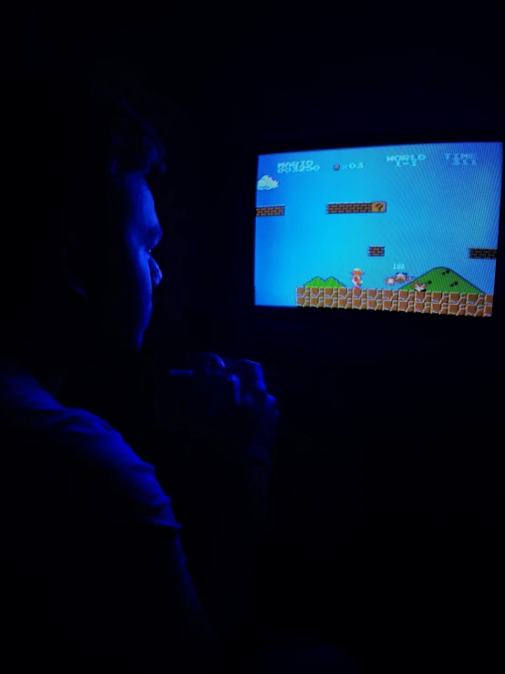 a man playing a video game in the dark, inspired by Mario Comensoli, profile image, boys, dark photo