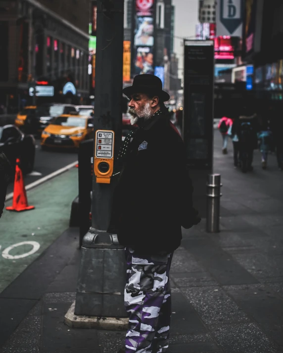 a man standing next to a parking meter on a city street, an album cover, pexels contest winner, street art, george clinton, times square, bushy white beard, full body photo