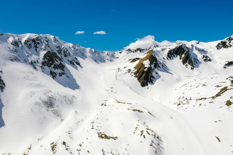 a man riding a snowboard down the side of a snow covered mountain, les nabis, in the center of the image, tourist photo, aerial photo, high quality product image”