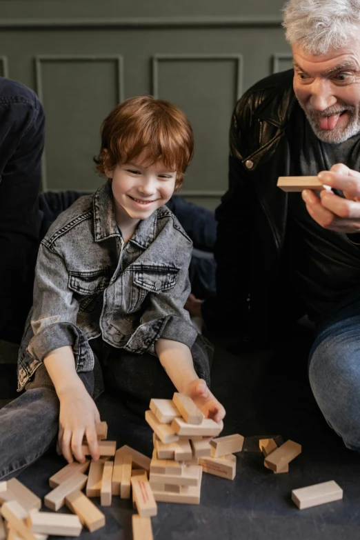 a man and a boy playing with wooden blocks, by Jan Tengnagel, pexels contest winner, red haired teen boy, happy family, 15081959 21121991 01012000 4k, a still of a happy