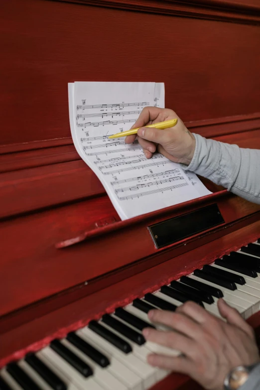 a close up of a person playing a piano, pen and paper, photographic hyperrealism, colour photograph, multi-part