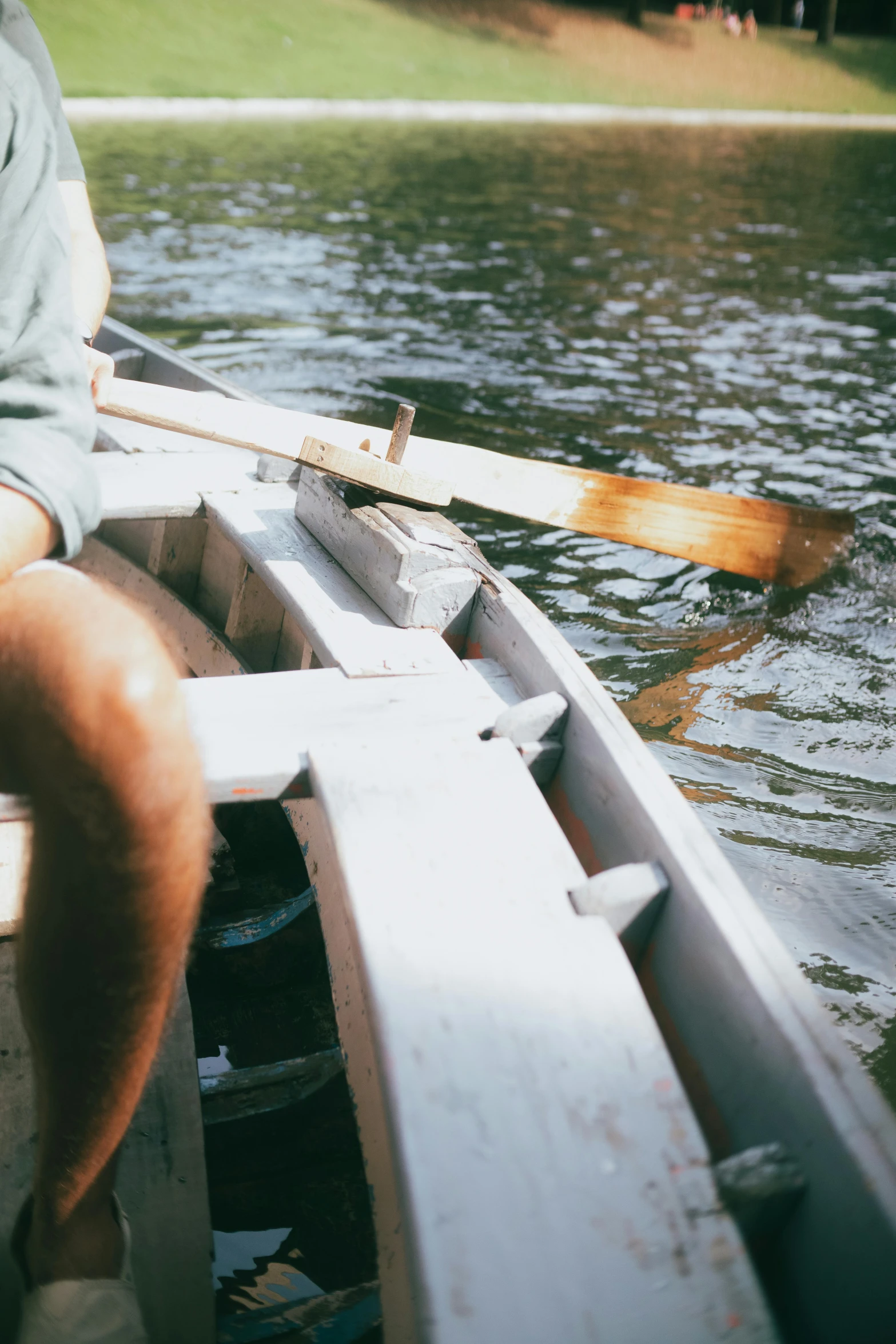 a man sitting in a row boat on a lake, zoomed in, promo image, levers, sturdy body