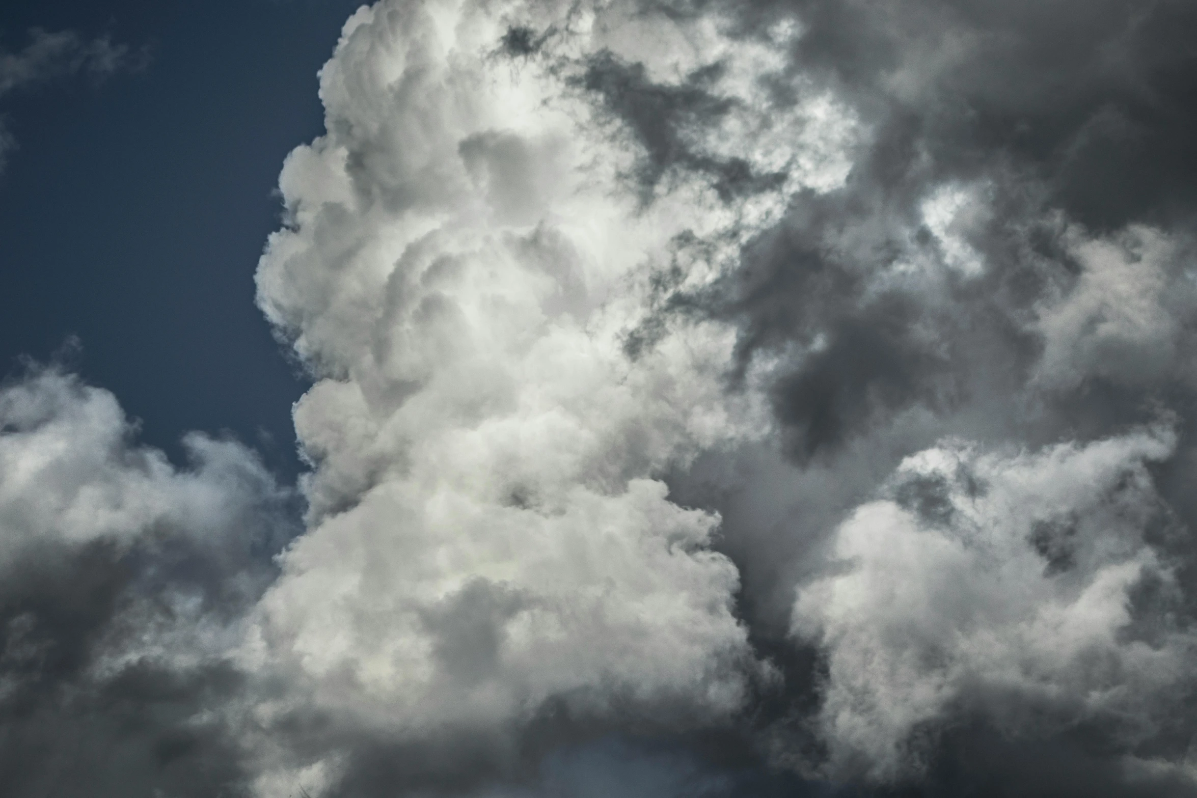 a jetliner flying through a cloudy blue sky, an album cover, unsplash, precisionism, giant cumulonimbus cloud, thick pigmented smoke, ignant, grey