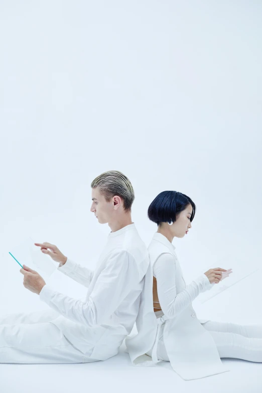 a couple of people that are sitting on the ground, by Fei Danxu, minimalism, wearing futuristic white suit, digital health, kiko mizuhara, smartphone