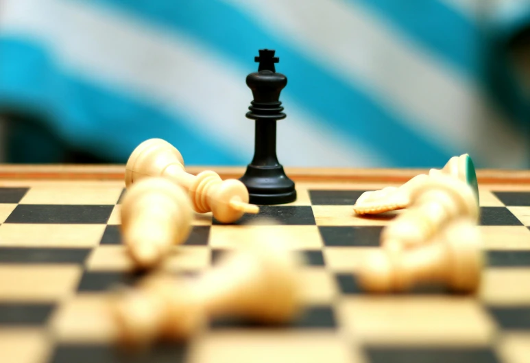 a black chess piece sitting on top of a chess board, by Carey Morris, unsplash, realism, black and cyan color scheme, leading a battle, 15081959 21121991 01012000 4k, snacks