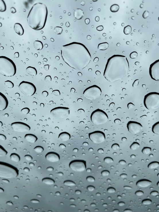 a close up of water droplets on a windshield, by Ryan Pancoast, promo image, grey, transparent carapace, hydration