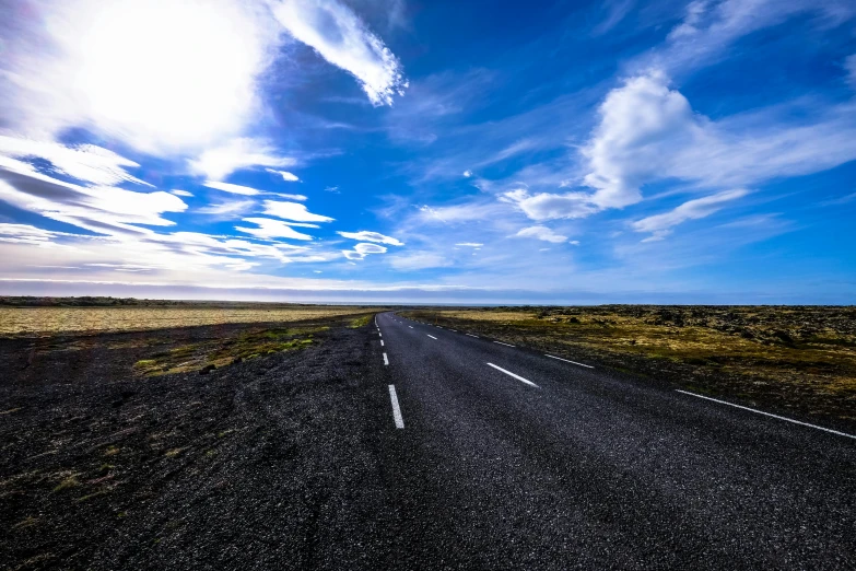 an empty road in the middle of nowhere, an album cover, by Hallsteinn Sigurðsson, unsplash, realism, big blue sky, square, panorama view of the sky, multiple stories