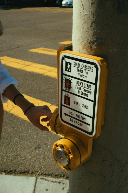 a man standing next to a yellow fire hydrant, a poster, by Matt Cavotta, reddit, hand controlling, crosswalk, buttons, instagram picture