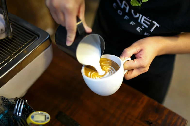 a person pouring milk into a cup of coffee, inspired by Ceferí Olivé, aussie baristas, sovjet, profile image, starlit