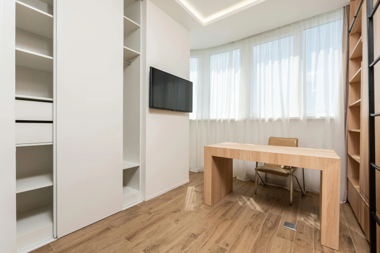 a living room filled with furniture and a flat screen tv, inspired by Albert Paris Gütersloh, unsplash, light and space, cubical meeting room office, small bedroom, krzysztof kononowicz, natural light outside