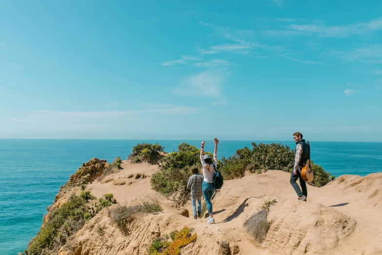 a couple of people standing on top of a cliff, views to the ocean, victorian arcs of sand, avatar image