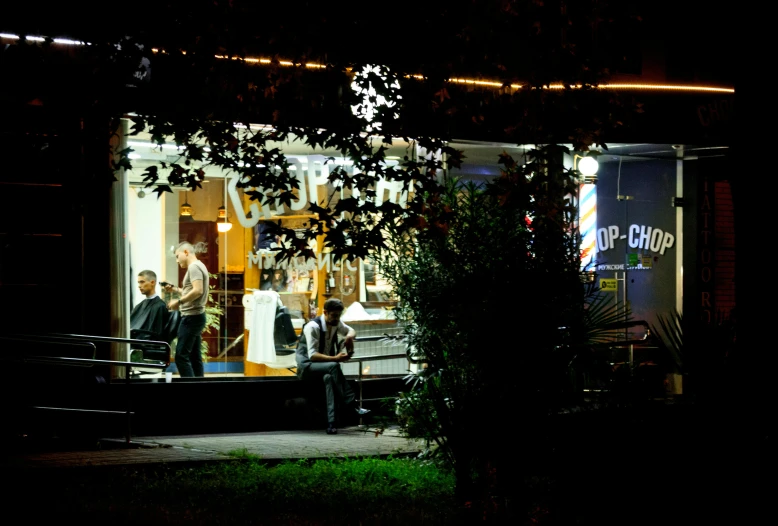 a group of people standing outside of a store at night, trailer park, lighting chiaroscuro, in 2 0 1 2, musician