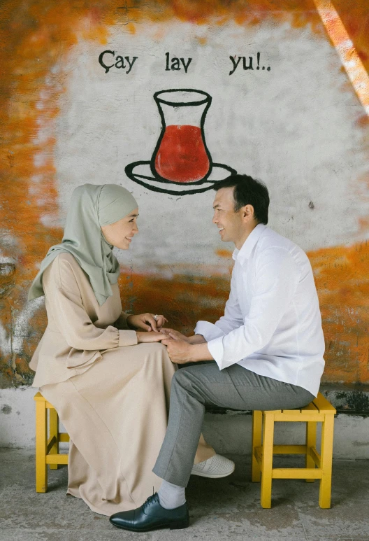 a man and a woman sitting next to each other, by Basuki Abdullah, pexels contest winner, hurufiyya, sitting on a mocha-colored table, 15081959 21121991 01012000 4k, greek ameera al taweel, square