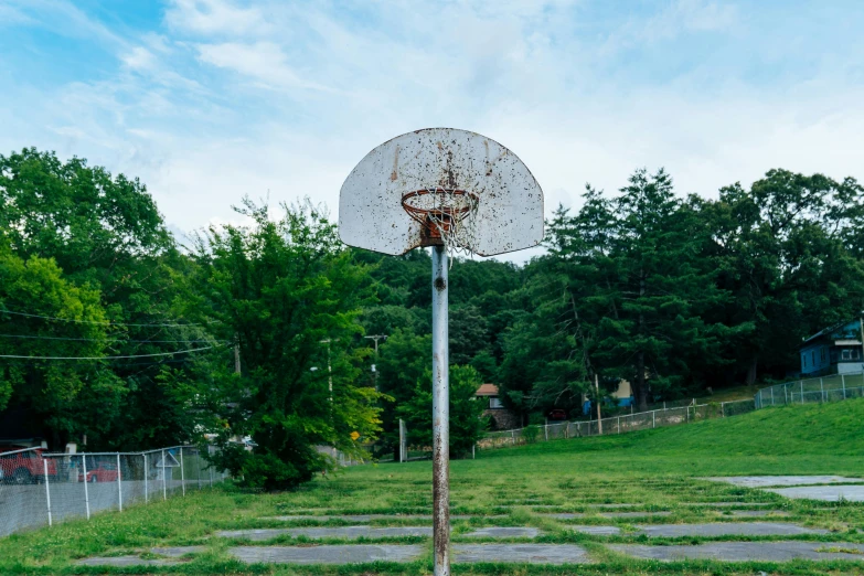 a basketball hoop sitting in the middle of a field, unsplash contest winner, process art, parks and public space, ai weiwei and gregory crewdson, playground, neighborhood