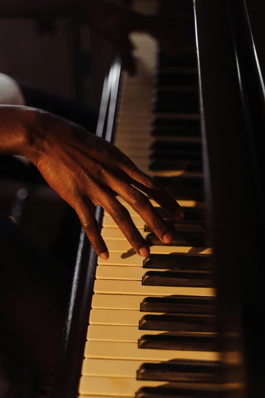 a close up of a person playing a piano, jemal shabazz, multiple stories, alabama, getty images