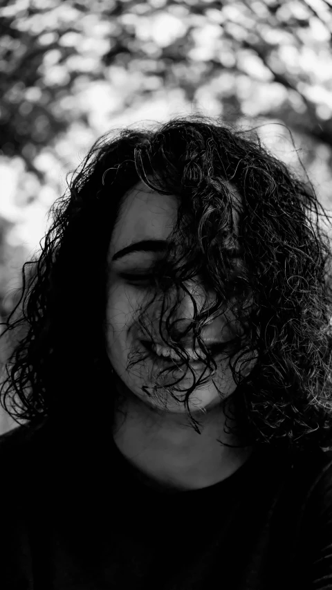 a black and white photo of a woman with curly hair, pexels contest winner, lush unkempt black hair, icon black and white, self deprecating, avatar for website