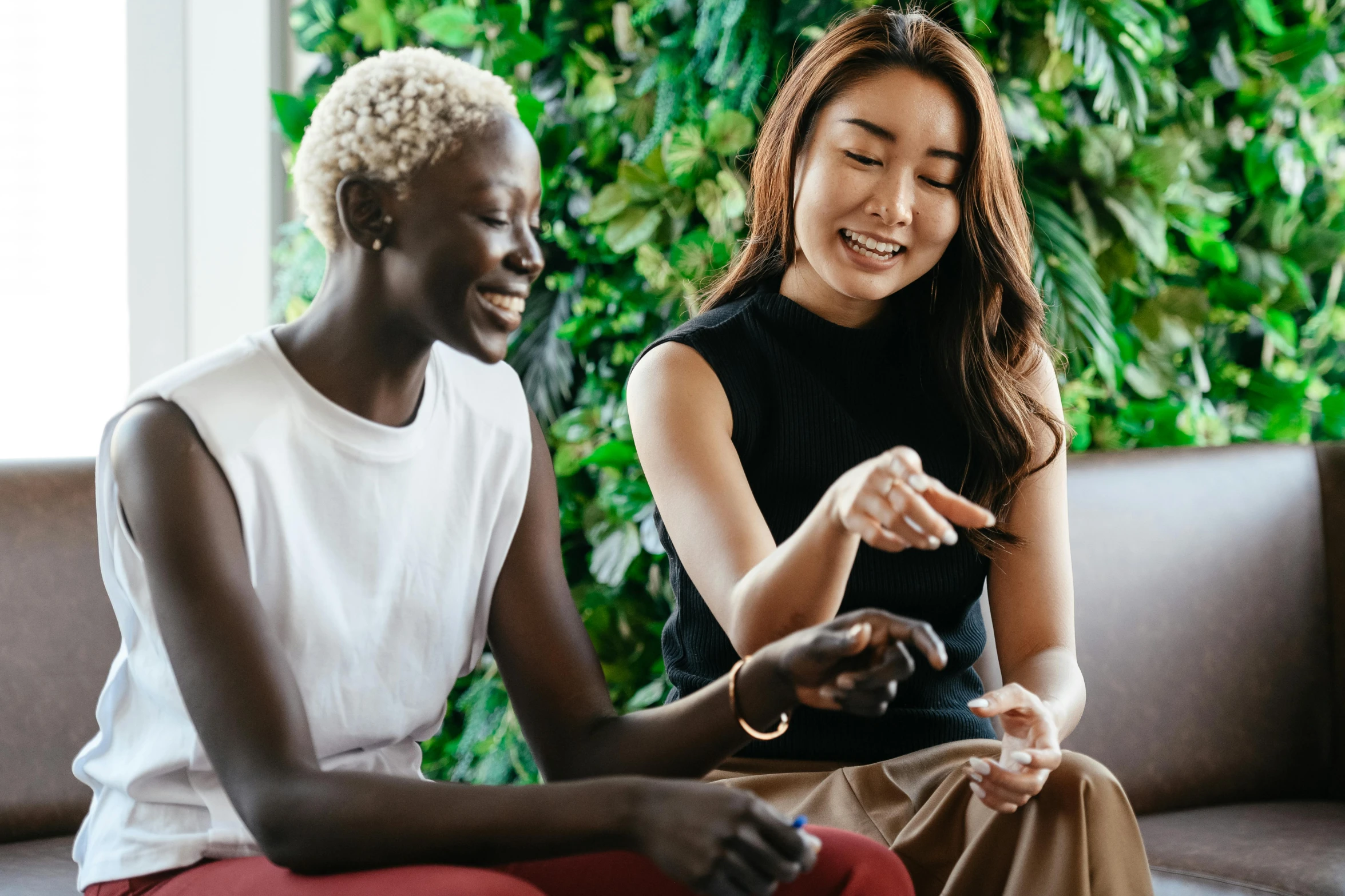 a couple of women sitting on top of a couch, trending on pexels, fiona staples and kinu nishimura, npc talking, sydney park, adut akech