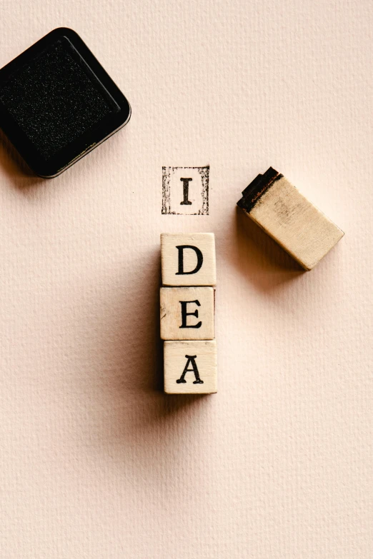 a wooden block with the word idea written on it, by Konrad Witz, trending on pexels, visual art, rubber stamp, lightbulb, 15081959 21121991 01012000 4k, seen from above