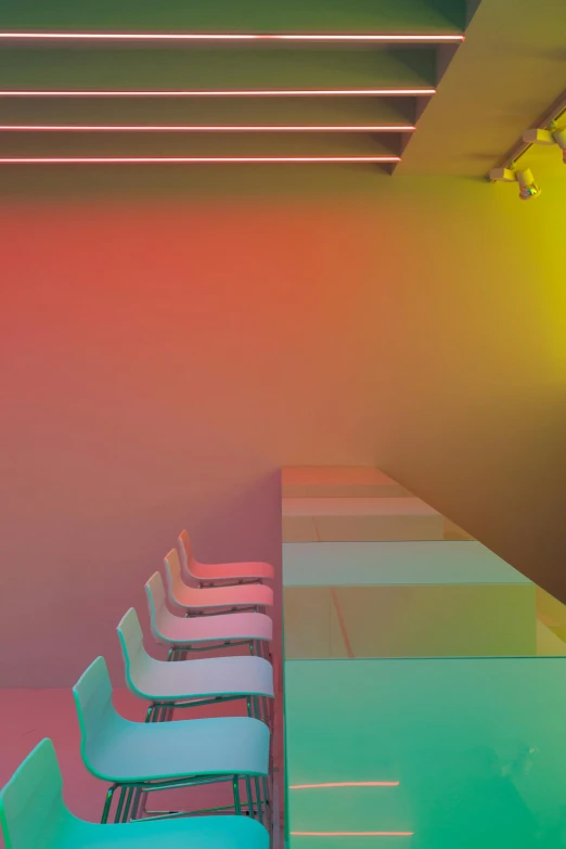 a group of chairs sitting in front of a long table, a digital rendering, by Peter Alexander Hay, rainbow lighting, led light strips, gradient red to yellow, rgb wall light