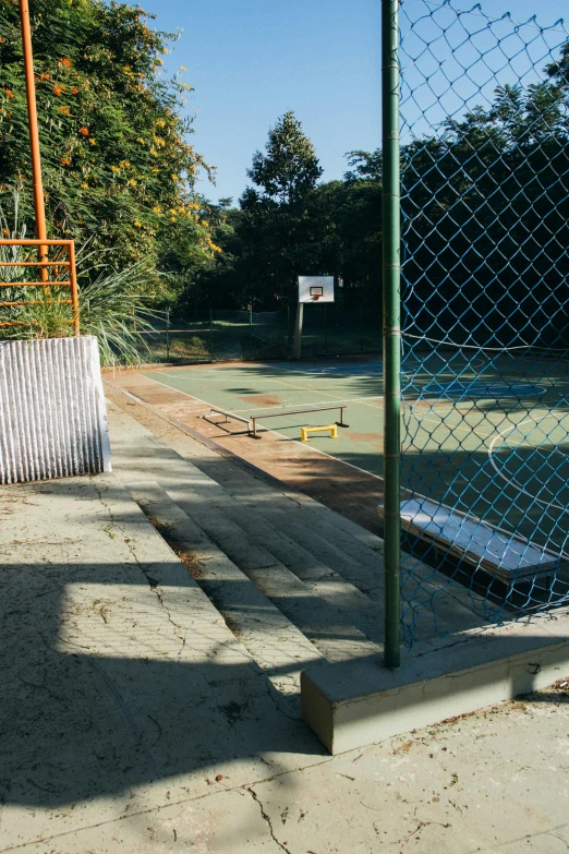 a view of a tennis court through a chain link fence, an album cover, dribble, barbizon school, skate park, steps, brown, high-angle