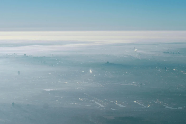 a view of a city from an airplane, unsplash contest winner, plasticien, floating lands in-clouds, sparse frozen landscape, hannover, clear sky above