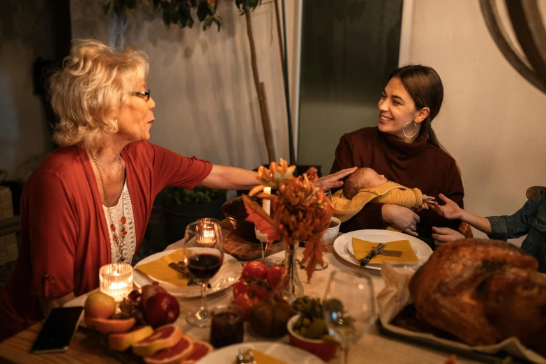 a group of people sitting around a dinner table, during autumn, profile image, woman holding another woman, multiple stories