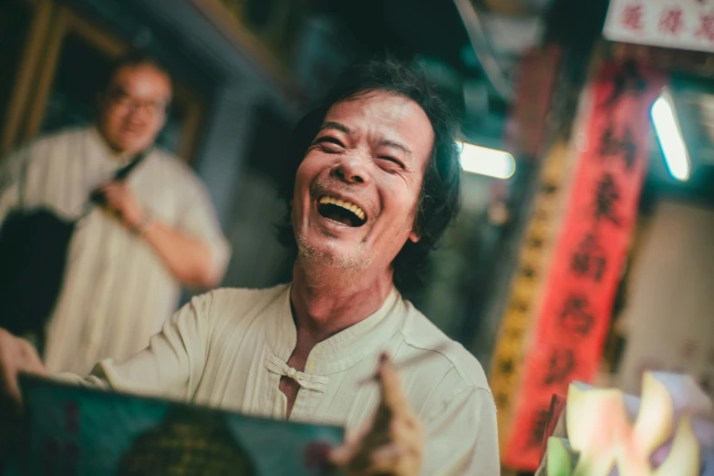 a man laughing while standing in front of a mirror, a picture, pexels contest winner, china town, avatar image, he is holding a large book, an oldman