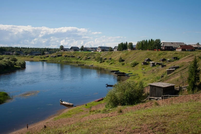 a body of water sitting next to a lush green hillside, hurufiyya, russian villages at background, ecovillage, stålenhag, official photo